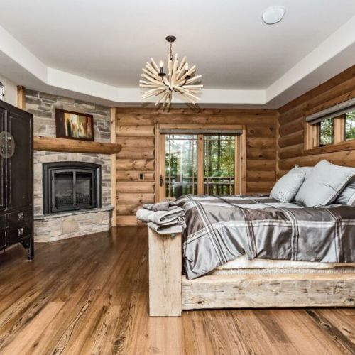 Stunning master bedroom on the main floor with its own fireplace and exit leading to the upper balcony.  Wait until you see the ensuite bathroom!